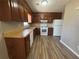This well-lit kitchen features wooden cabinets, laminate countertops and modern appliances at 5872 Fox Run, Rex, GA 30273