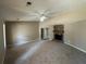 Spacious living room featuring a cozy fireplace and plush carpeting at 5872 Fox Run, Rex, GA 30273