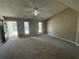 Bright living room featuring neutral paint and plush carpeting at 5872 Fox Run, Rex, GA 30273