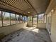 Enclosed porch featuring a corrugated metal roof, screened windows, and access to the backyard at 5872 Fox Run, Rex, GA 30273