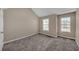Bright and spacious bedroom with neutral walls, two windows, plush carpeting, and a ceiling fan at 81 Sheffield Ln, Powder Springs, GA 30127