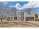 Charming two-story brick home with well-manicured lawn and attached two-car garage at 81 Sheffield Ln, Powder Springs, GA 30127