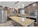 Kitchen boasts stainless steel appliances, dark wood cabinets, a granite countertop island and tile backsplash at 81 Sheffield Ln, Powder Springs, GA 30127