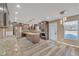 An open kitchen with an island, stainless steel appliances, tile backsplash, modern lighting, and wood flooring at 81 Sheffield Ln, Powder Springs, GA 30127
