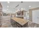 Open kitchen with dark wood cabinets, granite countertops and stainless steel appliances, with a large island at 81 Sheffield Ln, Powder Springs, GA 30127