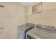 The laundry room with a folding shelf includes new, modern Samsung washer and dryer units at 81 Sheffield Ln, Powder Springs, GA 30127