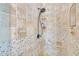 Detailed view of the tiled shower with stone accents and modern fixtures in a renovated bathroom at 81 Sheffield Ln, Powder Springs, GA 30127
