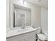 This bathroom features subway tile, a toilet, vanity with white countertop, and a large mirror at 1246 Bell Ave, East Point, GA 30344