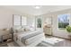 Bright bedroom featuring two windows, wood-look floors and neutral decor at 1246 Bell Ave, East Point, GA 30344