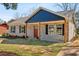 Inviting single-story home with a well-maintained lawn, stone walkway, and blue accents at 1246 Bell Ave, East Point, GA 30344