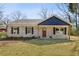 Charming brick home with a welcoming front yard, stone walkway, and dark shutters at 1246 Bell Ave, East Point, GA 30344