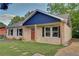 Charming single-story home with a well-manicured lawn and inviting front porch with natural wood supports at 1246 Bell Ave, East Point, GA 30344