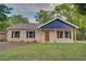 Charming brick home with newer roof, dark shutters, fresh landscaping, and well-manicured lawn at 1246 Bell Ave, East Point, GA 30344