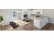Well-lit open-concept kitchen featuring stainless steel appliances, stone countertops and modern dining area at 1246 Bell Ave, East Point, GA 30344