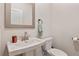 Modern half bathroom featuring a stylish sink, toilet and a decorative mirror and accessories at 1570 Halbrook Pl, Marietta, GA 30008