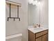 Modern half bathroom featuring a vanity, toilet and a decorative mirror and accessories at 1570 Halbrook Pl, Marietta, GA 30008