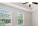 Bright bedroom with a tray ceiling, fan, and two large windows offering neighborhood views at 1570 Halbrook Pl, Marietta, GA 30008