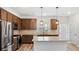 Modern kitchen featuring stainless steel appliances, granite countertops, and a central island with pendant lighting at 1570 Halbrook Pl, Marietta, GA 30008