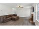 Cozy living room with a brick fireplace, ceiling fan, and comfortable seating area at 4975 Rockstone Way, Acworth, GA 30101