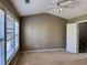 Spacious bedroom with vaulted ceilings, carpet flooring, ceiling fan, and a door leading to a hallway at 51 Highoak Ne Dr # 12, Marietta, GA 30066