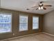 Bedroom featuring two windows, a ceiling fan, and neutral carpeting at 51 Highoak Ne Dr # 12, Marietta, GA 30066