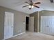 Bedroom featuring three closets and a ceiling fan for ultimate storage at 51 Highoak Ne Dr # 12, Marietta, GA 30066