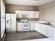 Bright kitchen features white cabinets, updated appliances and modern wood-look flooring at 51 Highoak Ne Dr # 12, Marietta, GA 30066