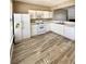Well-lit kitchen features white cabinets, updated appliances and modern wood-look flooring at 51 Highoak Ne Dr # 12, Marietta, GA 30066