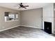 Spacious living room featuring a fireplace, wood-look floors and an open view to the kitchen at 51 Highoak Ne Dr # 12, Marietta, GA 30066