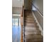 Carpeted staircase leading to the upper level of the home, with wood trim and railings at 51 Highoak Ne Dr # 12, Marietta, GA 30066