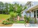 Spacious backyard featuring lush landscaping, greenhouse, garden beds, and pea gravel paths at 1518 Robins Walk, Alpharetta, GA 30005