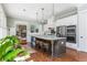 Well-lit kitchen with island seating, stainless steel appliances, and an open view to living room fireplace at 1518 Robins Walk, Alpharetta, GA 30005