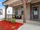 Inviting front porch with brick accents, outdoor seating, and decorative plants welcomes guests at 2456 Hidden Creek Rd, Kennesaw, GA 30152