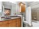 Bathroom featuring a single sink vanity with wooden cabinets and a shower-tub combo at 825 Highland Ln # 1105, Atlanta, GA 30306