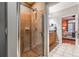 Tiled bathroom and glass enclosed shower offering a glimpse into the main bedroom at 825 Highland Ln # 1105, Atlanta, GA 30306