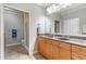 Bathroom featuring double vanity sinks, large mirror, and walk-in glass shower at 825 Highland Ln # 1105, Atlanta, GA 30306