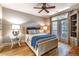 Comfortable bedroom with a ceiling fan and private access to a balcony with natural light at 825 Highland Ln # 1105, Atlanta, GA 30306