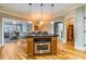 Kitchen island with stainless oven and cooktop offering seamless flow into an adjacent sitting room at 825 Highland Ln # 1105, Atlanta, GA 30306