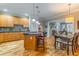Open-concept kitchen with island seating flows into the dining area and living room with fireplace at 825 Highland Ln # 1105, Atlanta, GA 30306