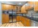 Bright kitchen features stainless steel appliances, wooden cabinets and light hardwood floors at 825 Highland Ln # 1105, Atlanta, GA 30306