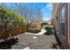 Cozy backyard featuring a mulched garden, decorative shrubs, and a stone patio with outdoor seating at 2330 Ventana Xing # 10, Marietta, GA 30062