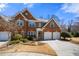 Beautiful brick home with a three-car garage, manicured lawn, and inviting front entrance at 2330 Ventana Xing # 10, Marietta, GA 30062