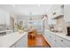 Well-lit kitchen showcasing white cabinetry, hardwood floors, and an adjacent breakfast nook at 2330 Ventana Xing # 10, Marietta, GA 30062