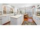 Well-lit kitchen showcasing white cabinetry, hardwood floors, and an adjacent breakfast nook at 2330 Ventana Xing # 10, Marietta, GA 30062