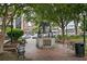 Statue of a bell in the park setting with benches, greenery, and buildings in the background at 2330 Ventana Xing # 10, Marietta, GA 30062