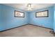 Bright bedroom with blue walls, a ceiling fan, and two windows at 3406 Woodview Se Dr, Smyrna, GA 30082