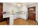 Traditional eat-in kitchen featuring white cabinets, a double sink, and a wood-paneled accent wall at 3406 Woodview Se Dr, Smyrna, GA 30082