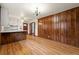 Eat-in kitchen featuring white cabinets, laminate countertops, and rich wood paneling and flooring at 3406 Woodview Se Dr, Smyrna, GA 30082