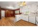 Combined kitchen and dining area featuring white cabinetry, laminate counters, and wood-paneling at 3406 Woodview Se Dr, Smyrna, GA 30082