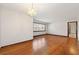 Minimalist living room with chandelier, gleaming hardwood floors, neutral colors, and large window at 3406 Woodview Se Dr, Smyrna, GA 30082